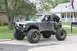1984 Ford Bronco II - This heavily modified SUV is parked on a residential street, ready for off-road adventures.
