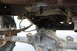 1984 Ford Bronco II - Close-up of the rear axle and suspension components on a vehicle, showing signs of age and use.