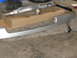 2001 Pontiac Trans Am - Car parts, including a bumper and exhaust, are laid out on a garage floor.