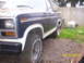 1982 Ford Bronco - This 1982 Ford Bronco features a two-tone dark blue and white paint scheme, visible from the front fender to the door.