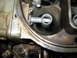 1985 Ford Mustang - A close-up view of the internal components of a carburetor, showing a fuel delivery tube.