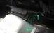 1985 Ford Bronco - Close-up view of an engine mount bracket, highlighting mounting points with green arrows.