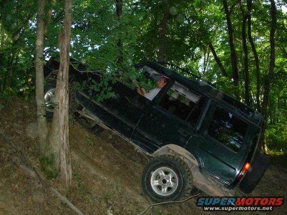 10061240climb.jpg Greg wanted to hit this steep hill once more, and then I talked him into trying a trail where he flipped the 4-wheeler.