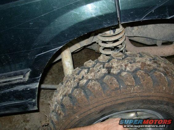 10061243broke.jpg But after several tries without success, and a LOUD snap, he backed out and we found the coil out of place, and the shock's lower stud ripped off the tube.

The starter wouldn't engage, either, so we called it quits and went back to the air conditioning.  An advantage of wheeling in your back yard!