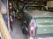 1970 Ford Ranchero - Rear view of a green 1970 Ford Ranchero with a tonneau cover, parked indoors.