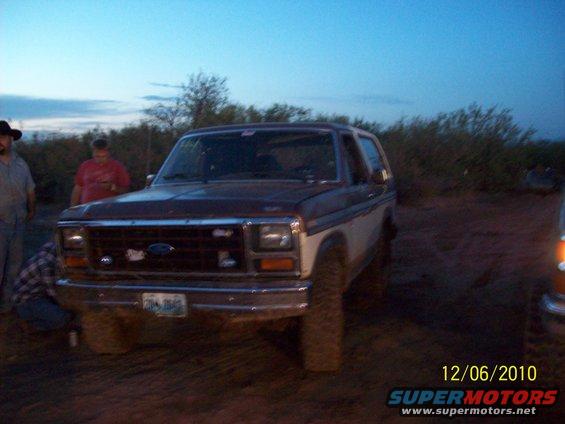 Brown and white Ford Bronco, 3/4 front view