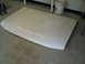 1990 Ford Bronco - A white car hood rests on a concrete floor, with a white bucket and a cart visible in the background.