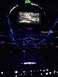 1996 Ford Bronco - An indoor arena is lit with purple and blue lights, with a large screen displaying a map overhead.