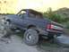 1987 Ford Bronco - This lifted 1987 Ford Bronco navigates a muddy off-road trail.