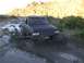 1987 Ford Bronco - This 1987 Ford Bronco is navigating a challenging muddy terrain, kicking up a large spray.
