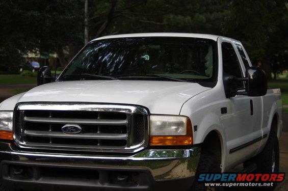 Front view of a white 1999 Ford F-250 pickup truck with a chrome grille