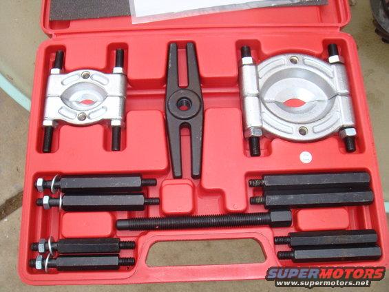 Red case with bearing separator tool kit inside. Includes clamps, puller, and various threaded rods