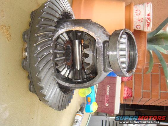 Differential assembly with ring gear and pinion gears, metal bearings visible