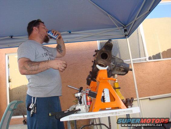 Front axle assembly on orange jack stands, outdoors