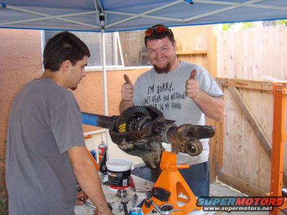 Differential assembly on orange jack stand with two men