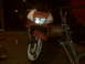 1991 Honda CBR-RR - A red and white Honda motorcycle is parked outdoors at night, with its headlight illuminated.