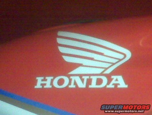 Red surface with white Honda wing logo and text