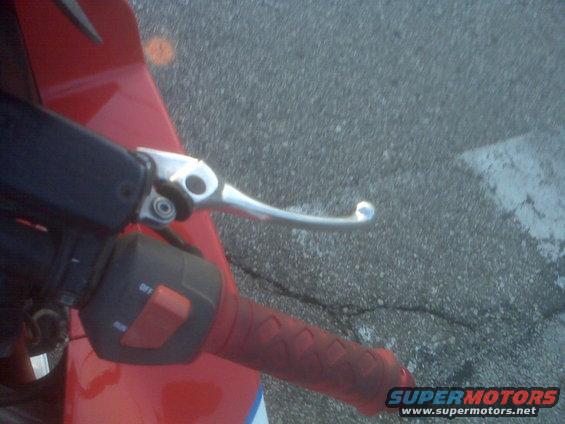 Motorcycle handlebar with clutch lever and red grip. Switchgear shows 'OFF' and 'RUN'