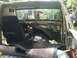 1988 Ford Bronco - The interior of a truck is shown with its dashboard removed and carpet torn, revealing its inner workings.