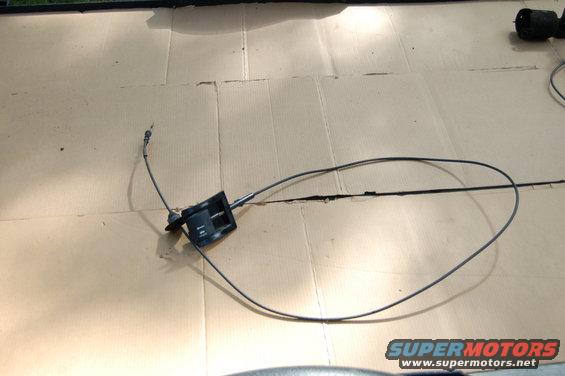 Hood release cable assembly with black plastic handle and metal cable