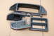 1988 Ford Bronco - Several dashboard trim components are laid out on a cardboard surface.