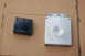 1988 Ford Bronco - Two electronic automotive parts, likely an ECU and its connector, are shown on a cardboard surface.