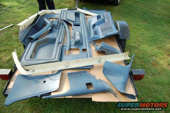 Blue interior trim parts laid out on a trailer