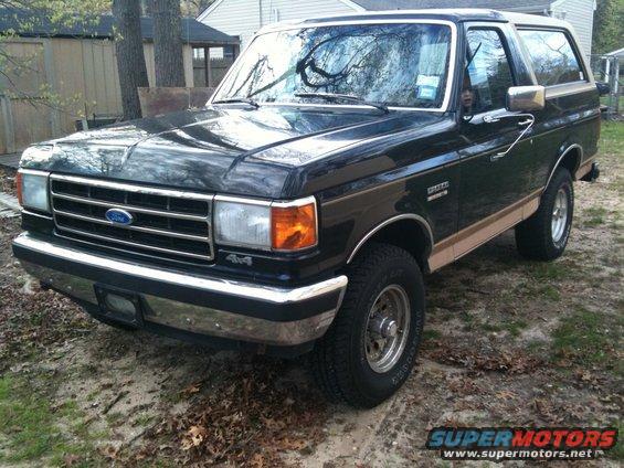 Black Ford Bronco with tan two-tone trim, front 3/4 view