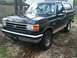 1989 Ford Bronco - This 1987 Ford Bronco is parked outdoors on a dirt lot.