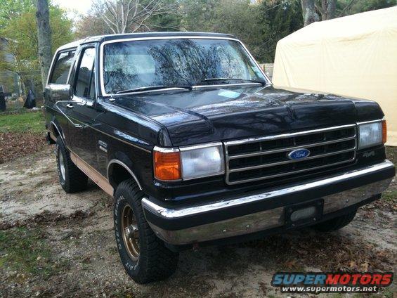 Black 1989 Ford Bronco with wood paneling, 3q-front view