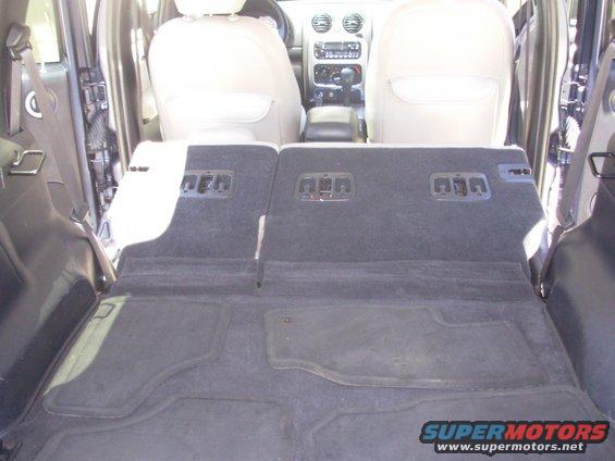 2002 Jeep Liberty interior, rear seats folded down, showing carpeted cargo area and dashboard
