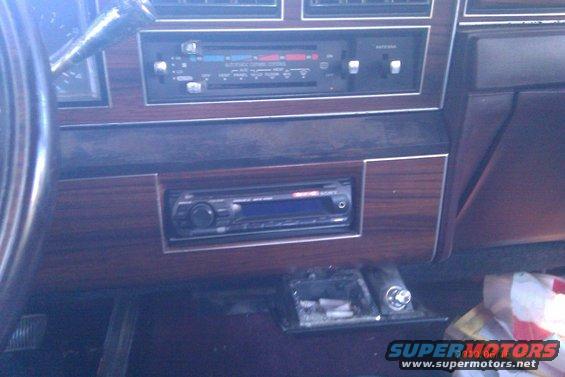 Interior dashboard with wood grain trim and aftermarket Sony stereo