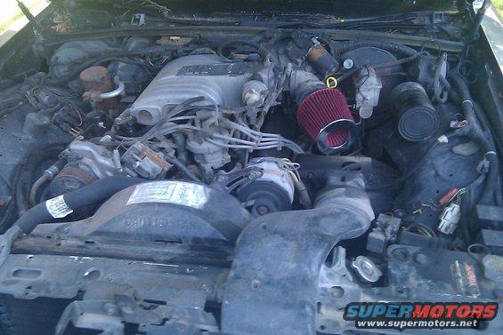 Engine bay with aftermarket air intake. Some labels are visible