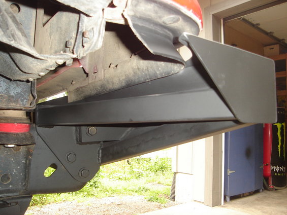 Aftermarket bumper part attached to vehicle frame, gray metal construction