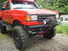 1989 Ford Bronco - This red 1989 Ford Bronco features a custom front bumper with a winch and auxiliary lights.