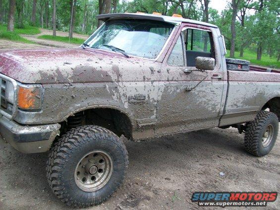 Mud-covered 1988 Ford F-150 pickup truck, 3q-front view