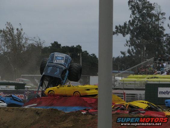 Monster truck crushing yellow cars