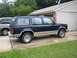 1991 Ford Explorer - Side view of a 1991 Ford Explorer parked in a driveway with another vehicle present.