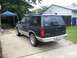 1991 Ford Explorer - The rear of a dark blue Ford Explorer is visible, parked in a residential driveway.
