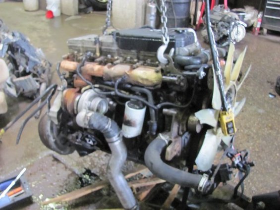 Engine with turbocharger and fan, suspended by chains