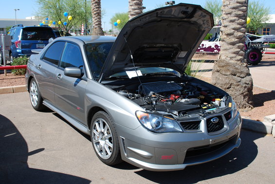 Gray 2005 Subaru Impreza sedan, hood open, showing engine