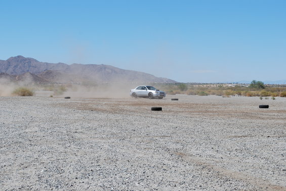Silver 2005 Subaru Impreza WRX STI kicking up dust on a track