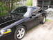 2003 Mercury Marauder - A black 2003 Mercury Marauder is parked on a gravel driveway next to a garage.