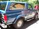 1995 Ford Bronco - This blue SUV is parked outdoors, showing its side profile with a spare tire carrier on the rear.