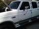 1995 Ford C-350 (Centurion Conversions) - This white 1995 Ford C-350 (Centurion Conversions) truck is viewed from the front passenger side with the hood open.