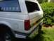 1995 Ford C-350 (Centurion Conversions) - Rear view of a white 1995 Ford C-350 (Centurion Conversions) showing the taillight and bumper.