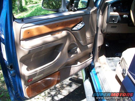 1995 Ford Bronco interior door panel with wood trim and power window controls