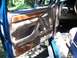 1995 Ford Bronco - Interior door panel of a 1995 Ford Bronco, showing wood trim and controls.
