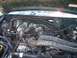 1995 Ford Bronco - The engine bay of a 1995 Ford Bronco is visible, with various components like the V8 engine and air intake clearly depicted.