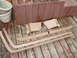 1989 Ford Bronco - Set of tan interior trim pieces for a vehicle, displayed on a weathered wooden deck.